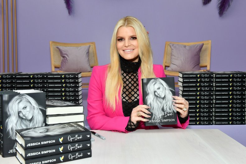Jessica Simpson poses with copies of book
