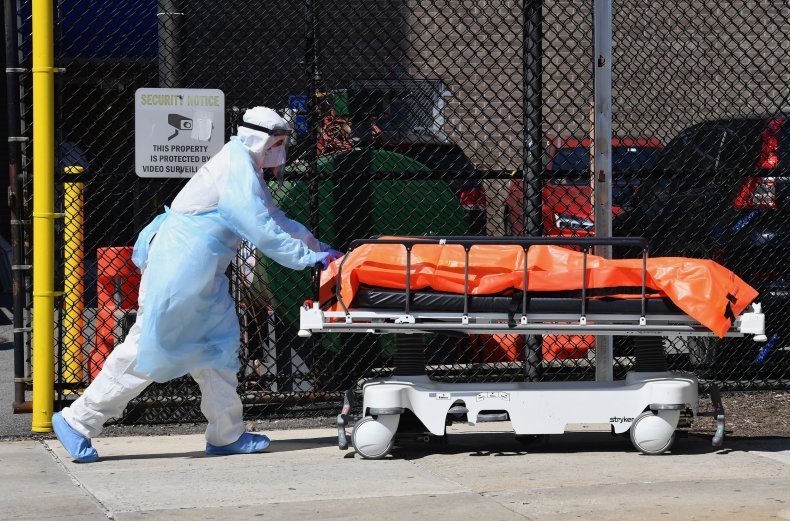 Medical staff move bodies