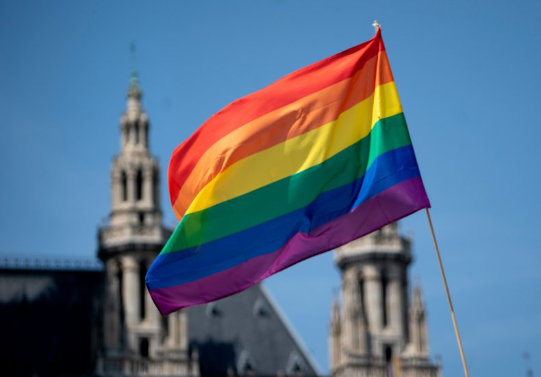 A rainbow flag LGBTQ+ pride flag flutters