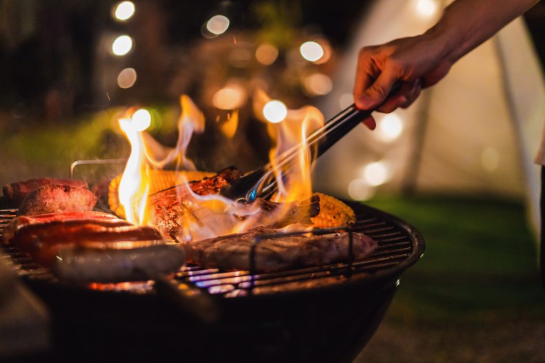 A person using a barbecue grill.