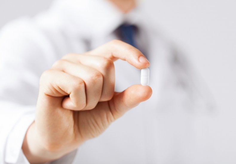 Doctor holding pill