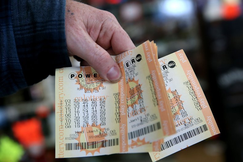 A customer holds Powerball tickets