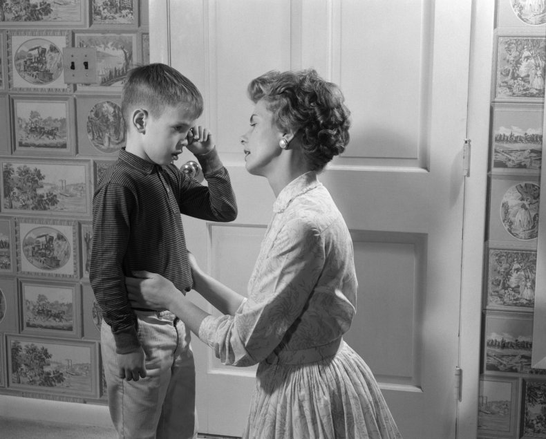 A mother consoling her son