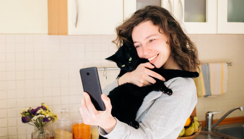 Woman poses for a selfie with cat