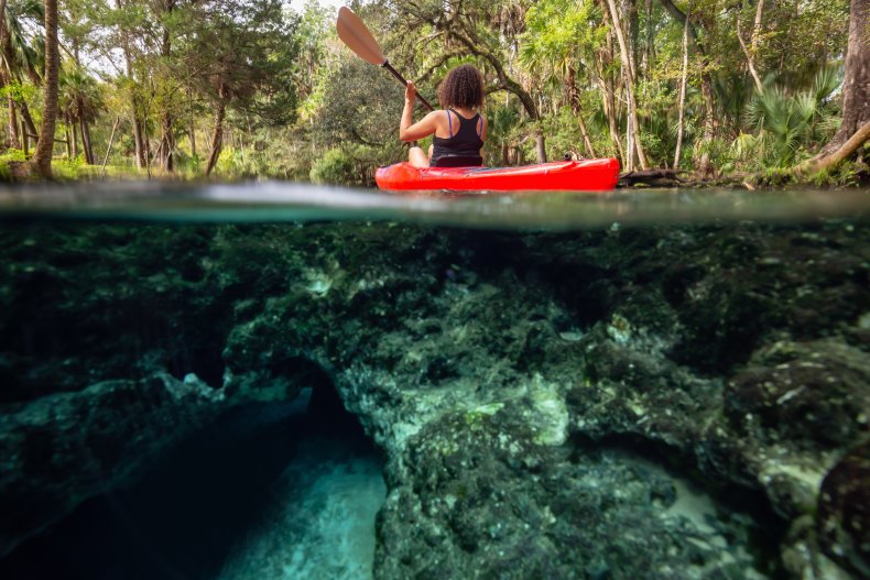A girl kayaking in a Florida river