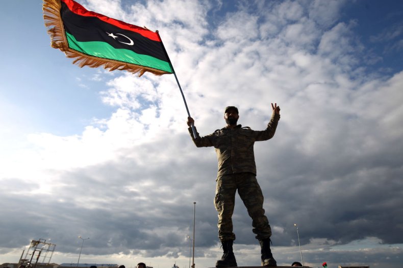 A Libyan soldier waves the national flag 