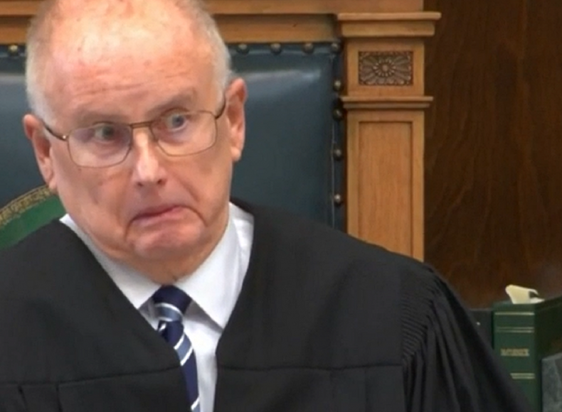 Judge Bruce Schroeder grimaces in court.