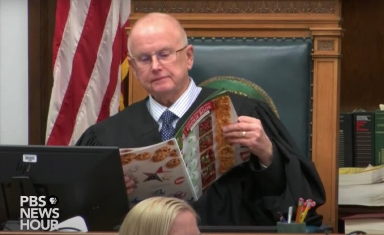 Judge Bruce Schroeder reads a cookie magazine.