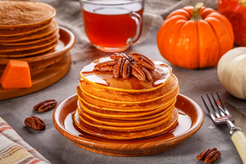 Pumpkin pancakes with pecans and maple syrup.