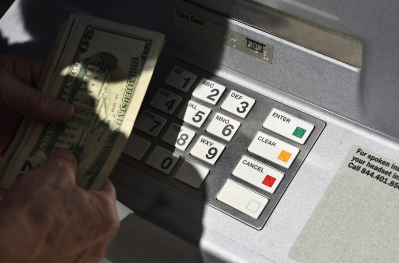 banking customer withdraws money from an ATM