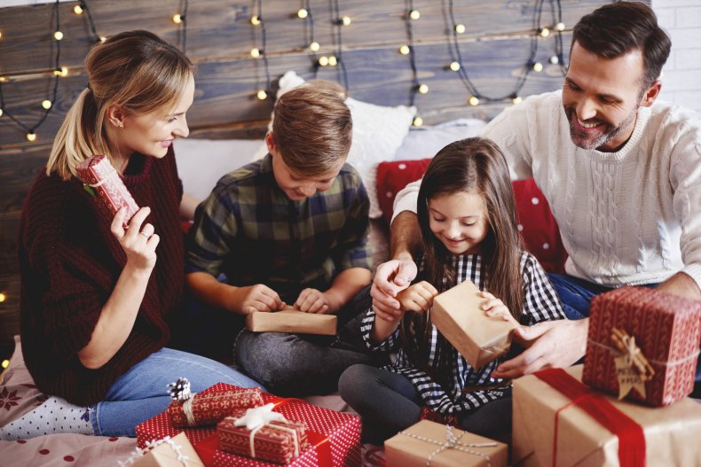 A family opening gifts together. 