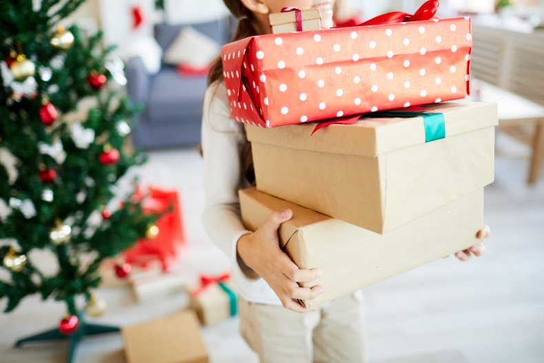 A child holding several boxes of gifts.
