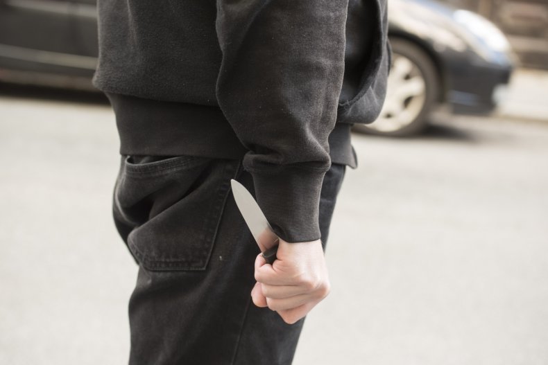 Man holding knife on the road