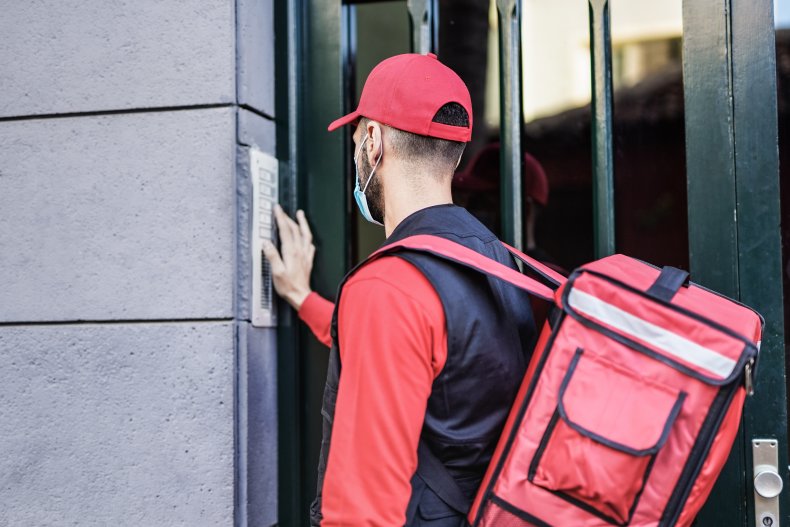 A delivery driver ringing a doorbell.
