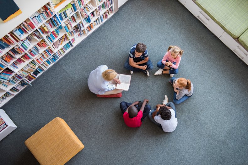 Librarian reading book to children