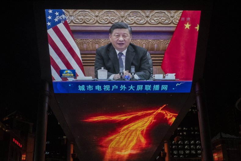 Large screen displays China's President Xi Jinping.
