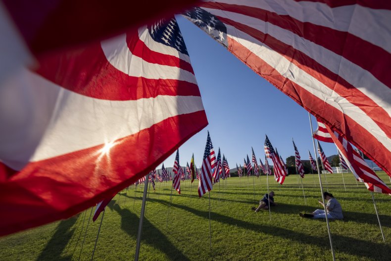 People sit among flags during the 14th