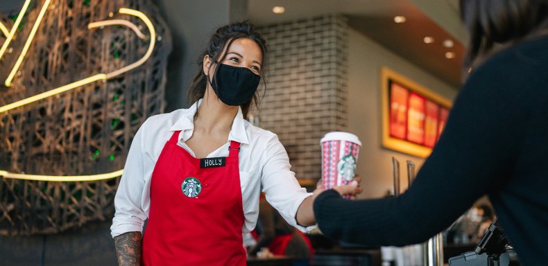 A Starbucks employee with a customer.