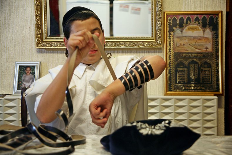 Young Jewish boy laying Tefillin