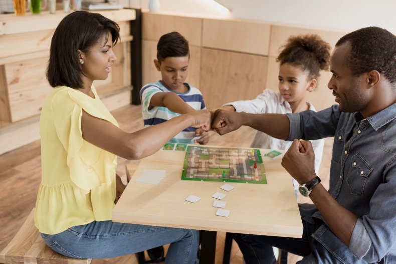 A family playing a board game. 