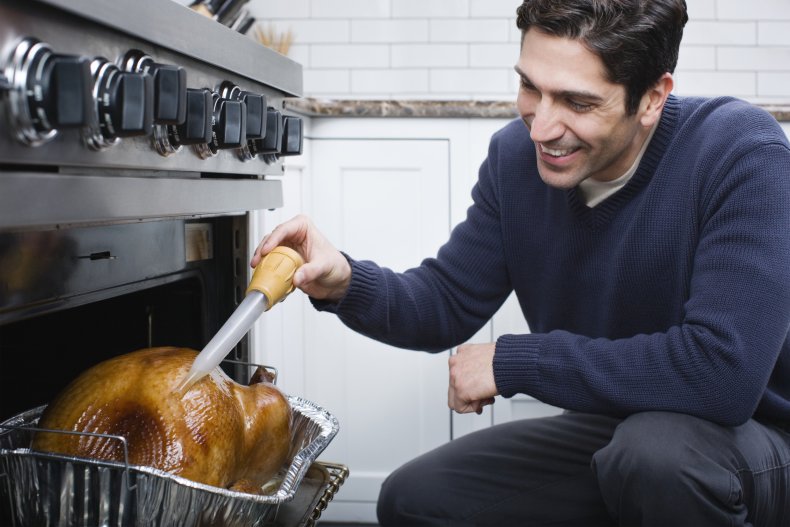 A man basting a turkey.