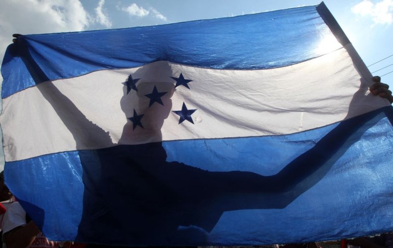 A man holds the flag of Honduras
