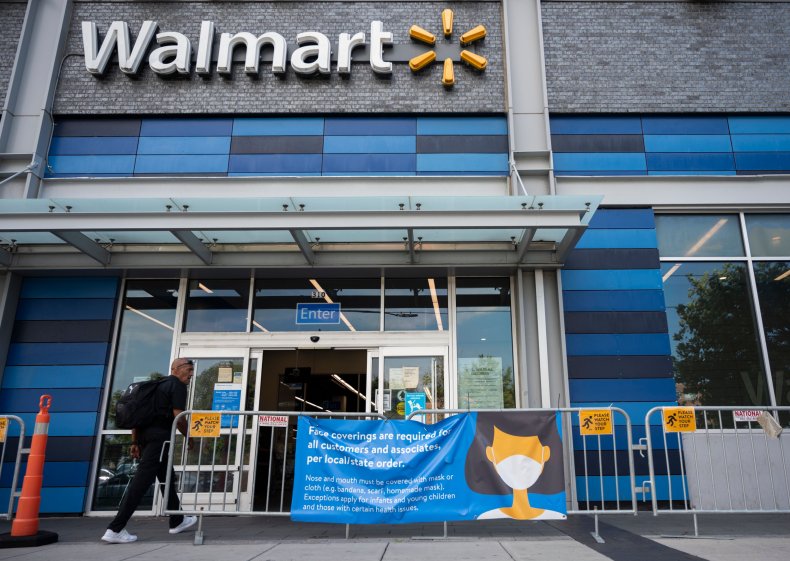 A man near a Walmart mask sign.