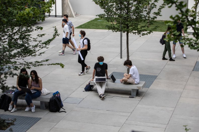 Students sit and walk on a campus