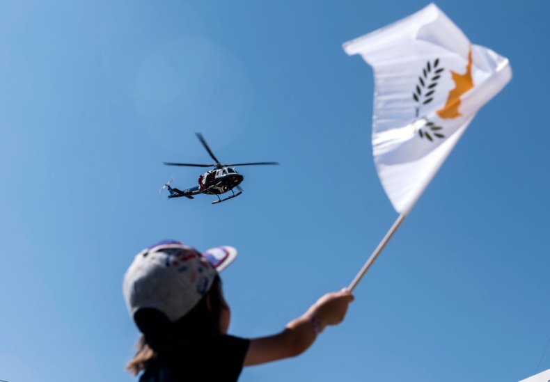 A child waves the Cypriot national flag