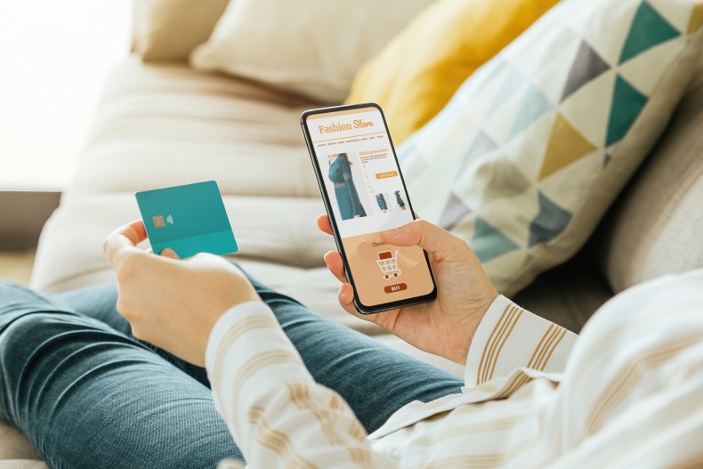 A person makes a purchase on his phone.