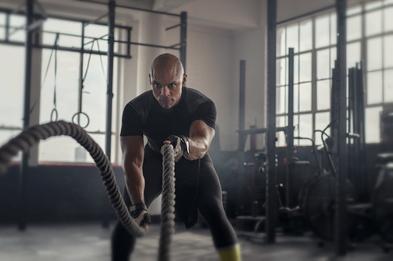 A man doing rope exercises. 