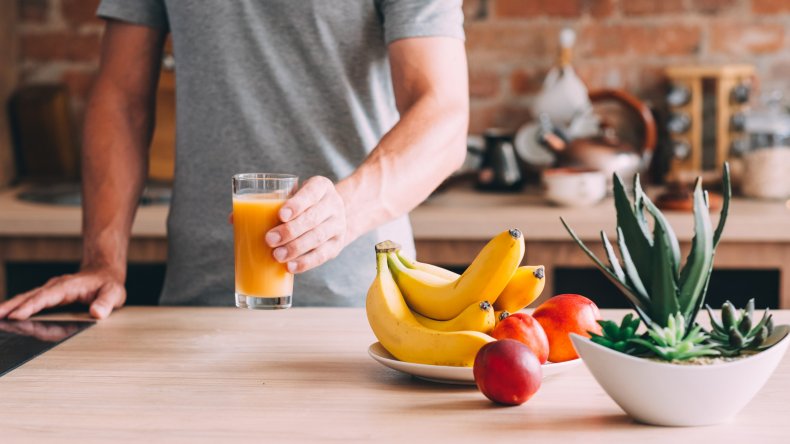 A bowl of fruit and orange juice.