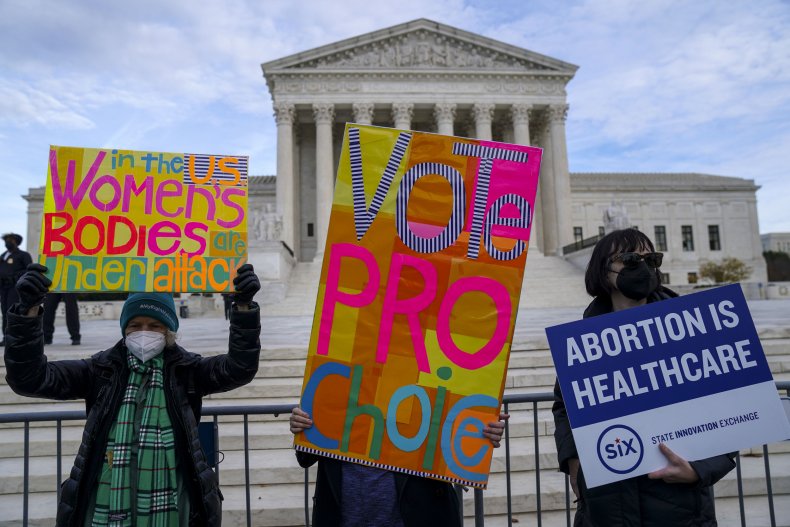 Participants hold signs during the Women's March