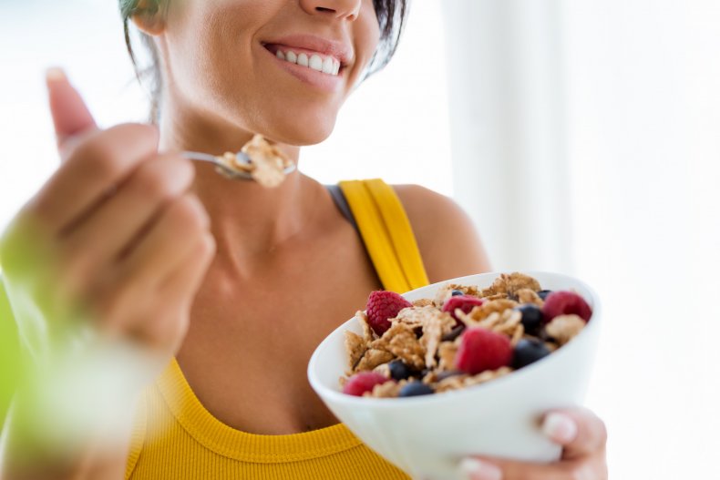 A woman having a bowl of cereal.