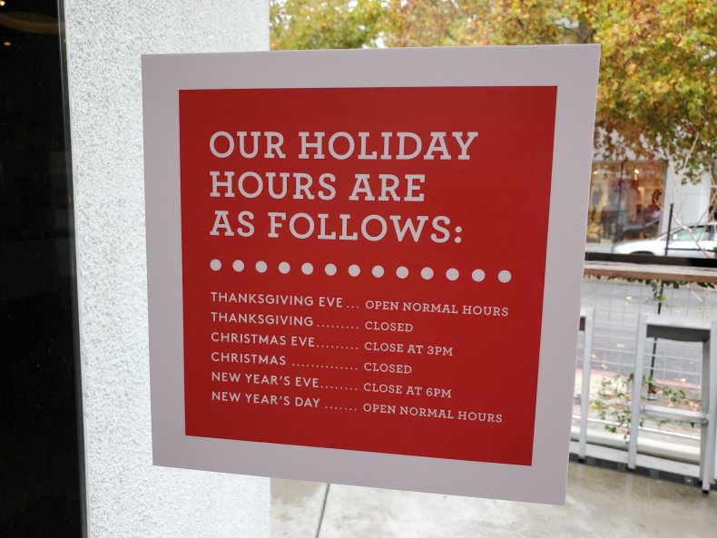 Signage showing holiday store hours in California.