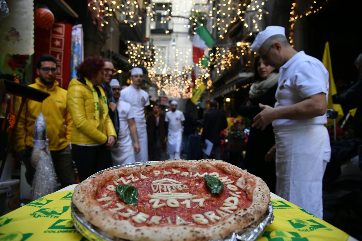 Neapolitan pizza makers showcase a pizza. 