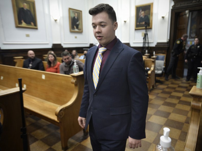 Kyle Rittenhouse walks through the courtroom