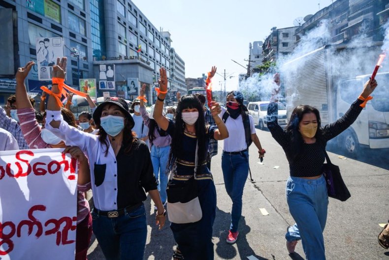 Protesters make the three-finger salute