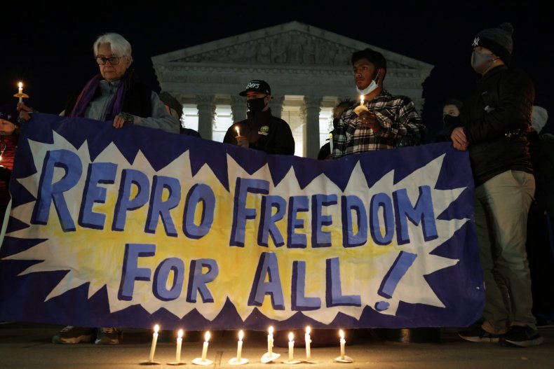 Activists participate in a candlelight vigil