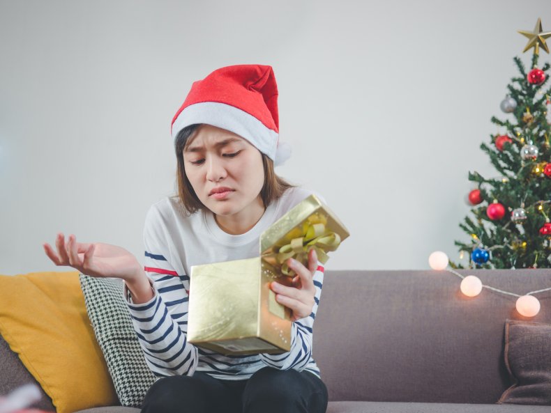 Woman looking unhappy with Christmas gift