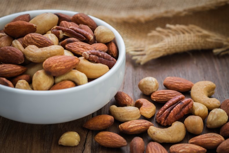 A bowl on nuts on a table.