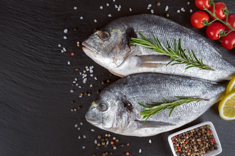 Dorado fish on a table with spices.