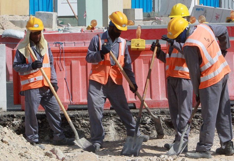 Workers are seen at a construction site 