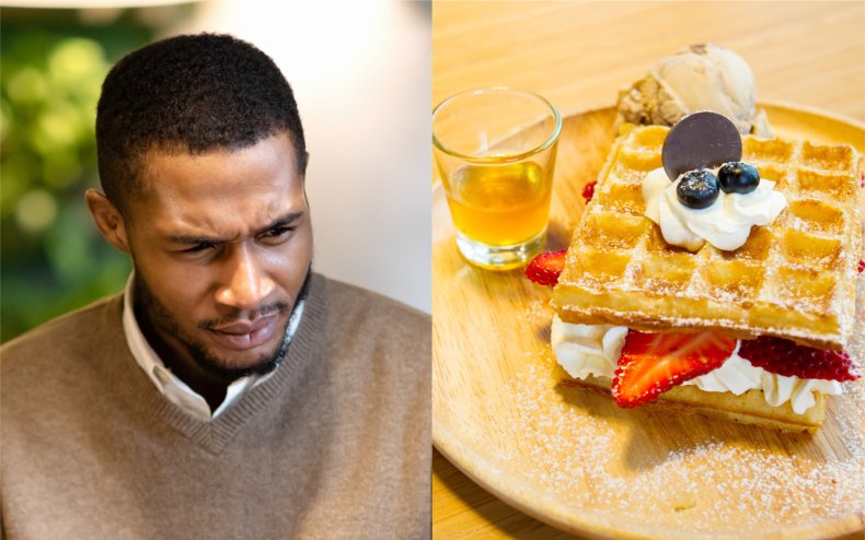 A man looking at some waffles.