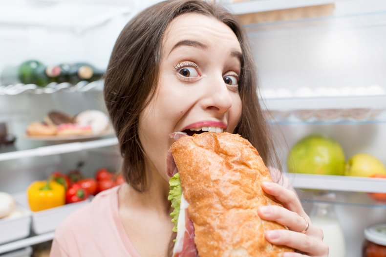 File photo of woman eating a sandwich.