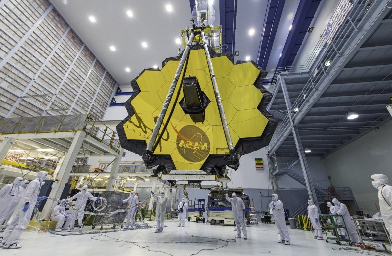 Technicians raise the James Webb Space Telescope.
