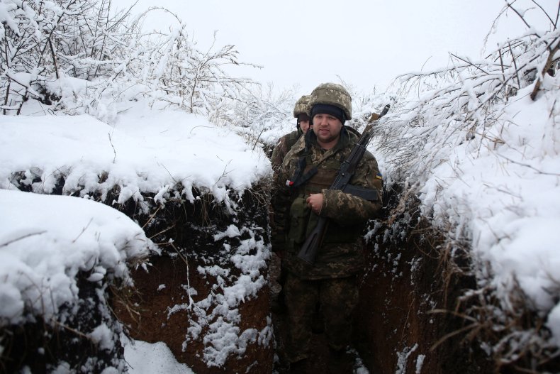 Ukrainian Servicemen Walk Through a Trench