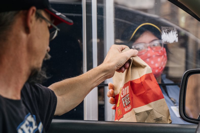 A man receiving a McDonald's order.