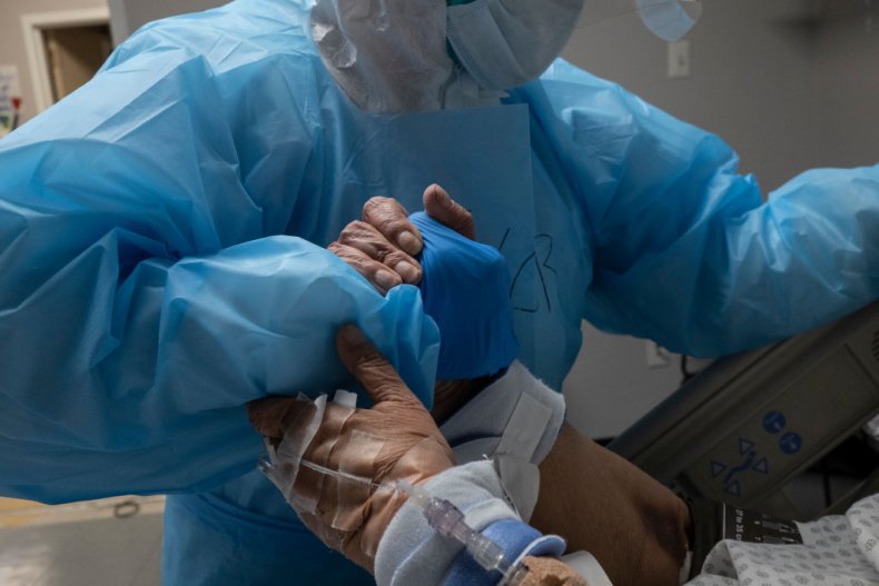 A medical staff member grabs a hand 
