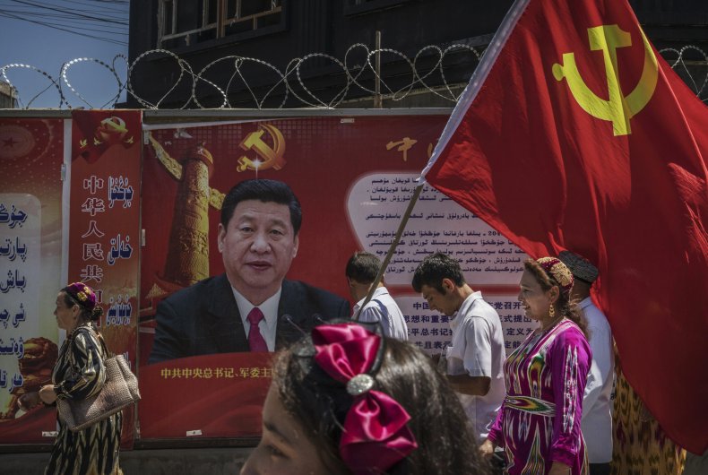 Uyghurs carry flag past Xi Jinping Xinjiang